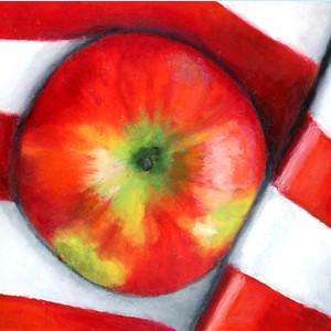 a red apple on red striped cloth